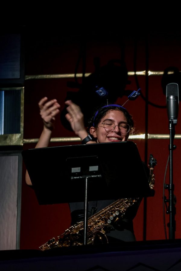 In the saxophone quintet playing “Klezmer Holiday,” band senior Karla De Jesus encourages the audience to clap along.