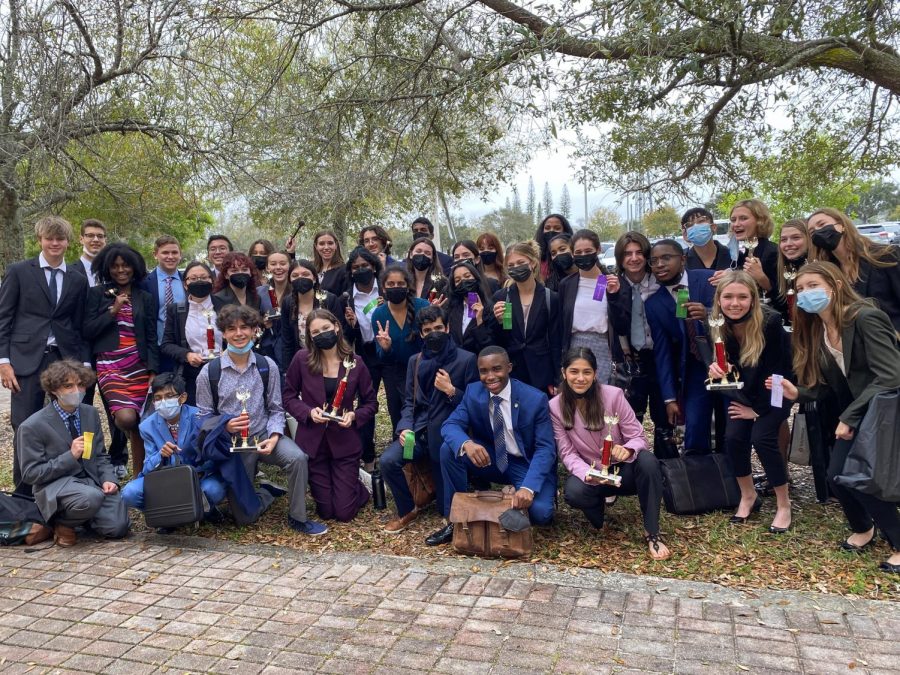 The Speech and Debate Team poses with each other and the awards they each earned at the tournament.
Photo courtesy of Angelia Capalbo.