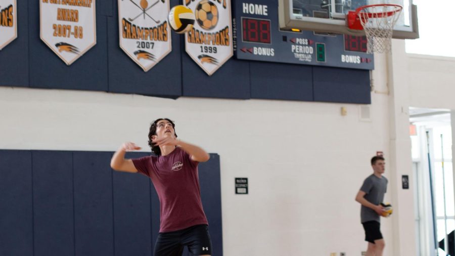 Vocal junior Matthew Stenberg prepares to hit the ball as it advances toward him.