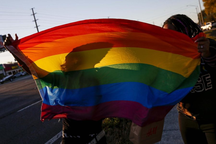 A Pride flag billows in the wind as students go to join a protest at Gaither High in Tampa, Florida, against what critics call the Dont Say Gay bills on Monday, Feb. 14, 2022. The Florida Legislature is under scrutiny over the bills that in part read, A school district may not encourage classroom discussion about sexual orientation or gender identity in primary grade levels or in a manner that is not age-appropriate or developmentally appropriate for students. (Ivy Ceballo/Tampa Bay Times/TNS)