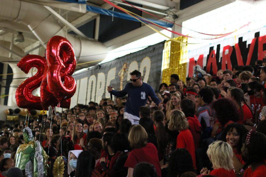 The juniors part as Biology teacher Stephen Anand searches for a bird in the junior section as part of the freshmen skit. 
