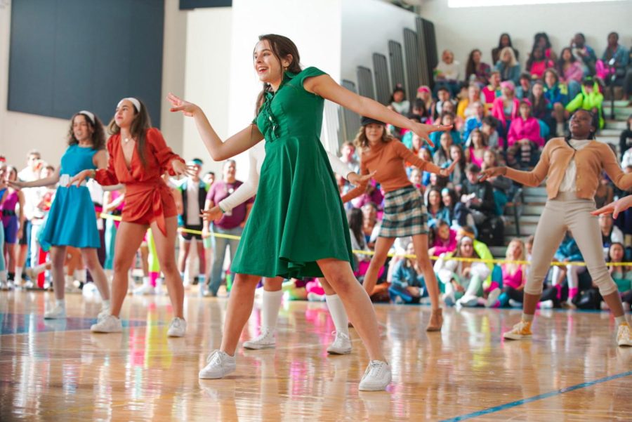 Wearing a 1960s-themed outfit, dance senior Lauren Hopta participates in the sophomore Generations Dance during the 2020 Spirit Week. For a ‘60s-themed outfit, sophomores can wear bright colors, long skirts or dresses, turtlenecks, cardigans, collars, and pinstripe suits. 