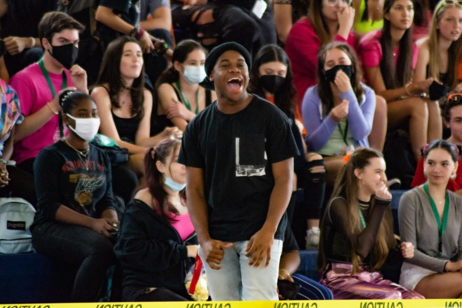 In front of the sophomore section, band junior Makens Joseph cheers as the games begin in the Gym during lunch for the first day of Spirit Week.