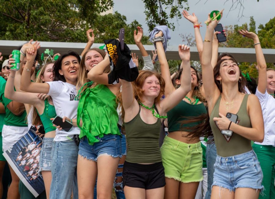 Sophomores, decked out in green gear for their St. Patrick’s day theme, jump, scream, and wave as the drone flies above the front of campus. Caption written by Olivia Metzler.