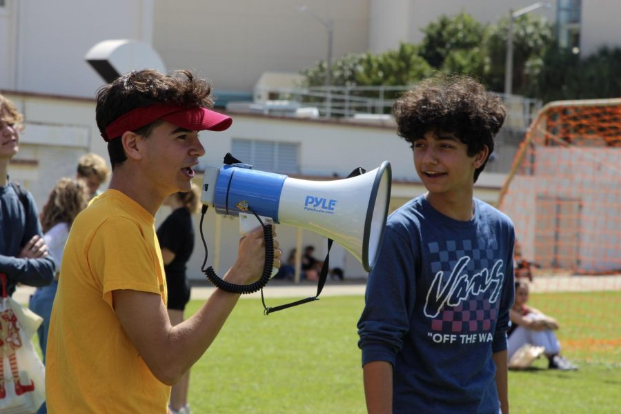 Communications senior Charlie Blackwell and communications junior Noah Haddad instruct students playing Capture the Flag on March 4. Photo courtesy of Julia Smerling. Photo caption by Dylan Dam.