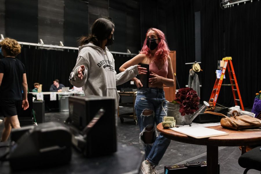 While they preset the stage for Act II as assistant stage managers, Peitz walks Gary through the layout of each prop and directs her on where to place each item.