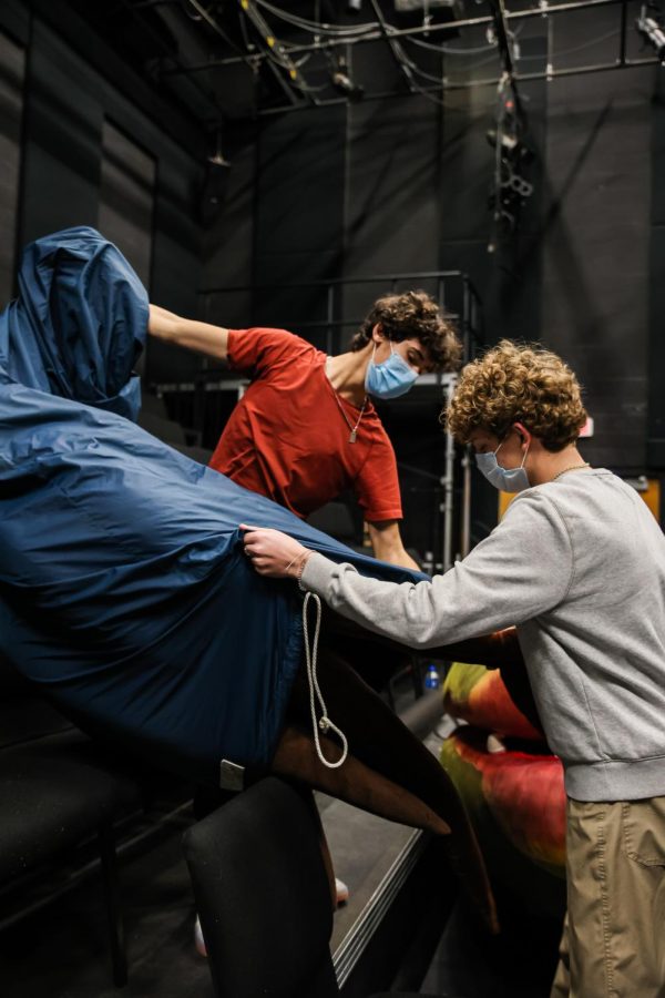 Theatre sophomores Jaden Casey and Gabriele Pettener work together to unveil the third Audrey II puppet in preparation for Act II. Throughout the show, they were responsible for helping theatre sophomore and puppeteer Lucas Lacey get in and out of the puppet and getting it ready for each scene.