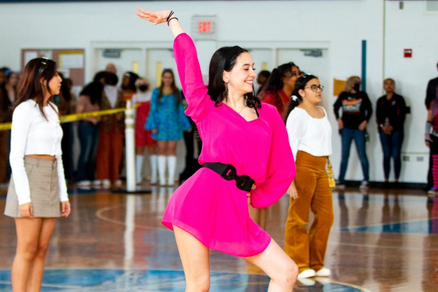 Dance sophomore Anna Sofia Machado strikes a pose with one hand in the air as “It’s My Party” by Lesley Core plays through the gym.