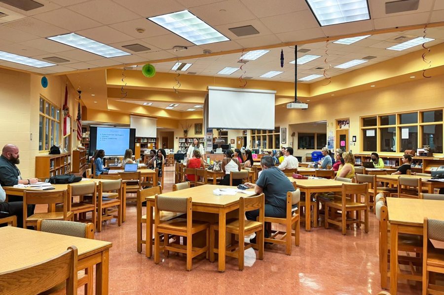 Members of the School Advisory Council (SAC) listen in as SGA Co-Historian and dance senior Jonelle Brinkley explains the progress the athletic department has made for the 2022-23 school year. She shared a list of the recent varsity sports activities, including team tryouts and upcoming schedules for the cross-country and swim teams. 
