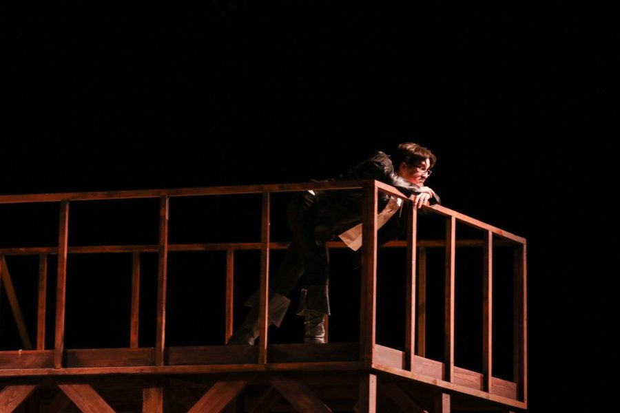 Theater junior Von Markarian looks off of the balcony on the set of “Shakespeare In Love” during rehearsals on Monday, Oct. 24. Students began designing and creating the elements of this set at the end of last year. “We had a professional painter, Sydney, come in and help us with the wood grating. I think it looks really good with the set, and I think it serves the show really well,” theatre junior Kylie Glassgold said. 