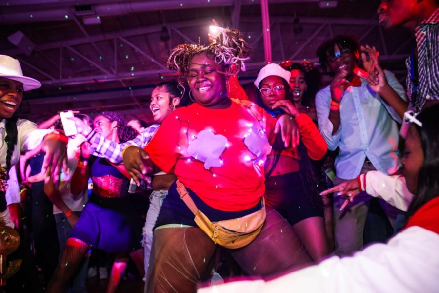 As a crowd gathers around her, visual junior Cherise Hightower dances along to “Hotel Room Service” by Pitbull at the Fall Dance on Oct. 13. An annual tradition allowing students to dress in their costumes and celebrate Halloween early, this year’s circus-themed dance included a haunted house, escape rooms, carnival games, and a DJ.
