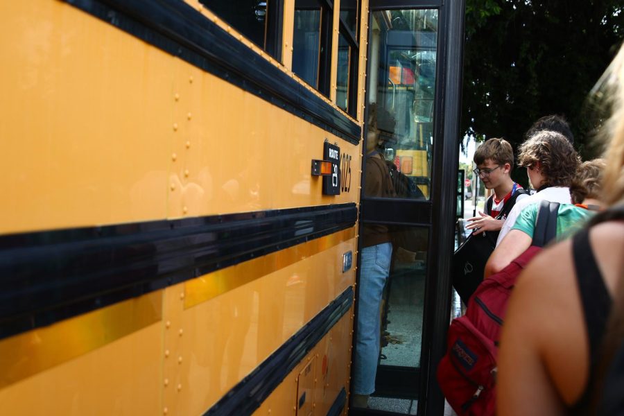 Students line up to get on their buses after being held in their fifth period on Sept. 21. An infestation of bees on campus caused parents to pick up their children in the bus loop while buses had to park along Iris Street.
