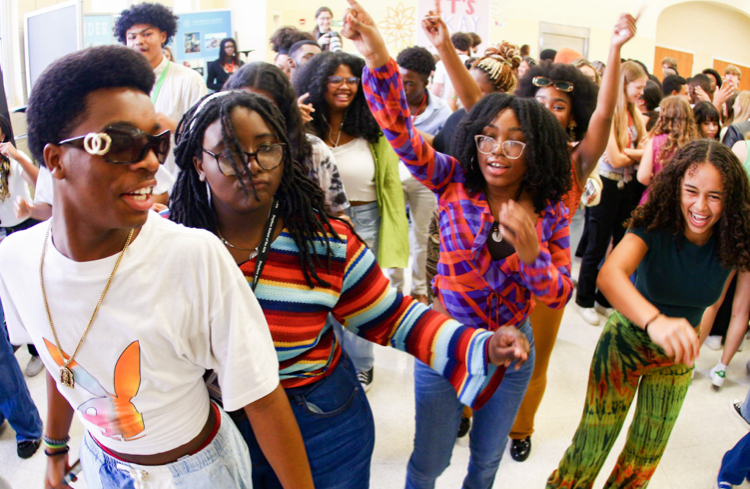 Black Student Union (BSU) members dance together in the cafeteria during the block party on Oct. 17. This event celebrated their heritage with music, dances, and ‘70s attire. 
