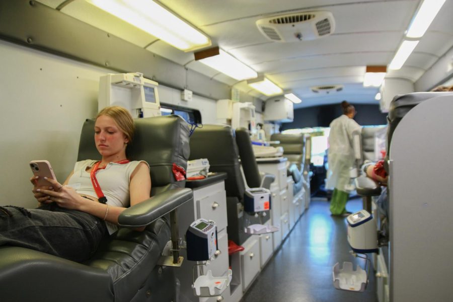 Preparing to donate blood, vocal junior Taylor Klein scrolls through her phone as she waits for the nurse. National Honor Society (NHS) hosted a Valentine’s Day-themed blood drive on Friday, Jan. 20, allowing eligible students to donate blood and platelets.
