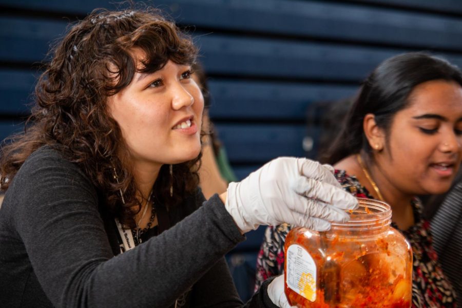 Vocal senior Amelia Williams passes out various foods at the Multicultural Potluck on Nov. 16 during lunch in the gym. Students across campus brought in foods that represent their culture and heritage.
