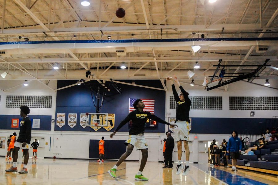 Basketball player and communications junior Josef Fiala takes a practice shot during pre-game warmups on Jan. 9. The boys basketball team won their home game against the Village Academy School. “It’s important to practice before games so you can get warmed up and mentally prepared for the game you are about to play,” Fiala said.
