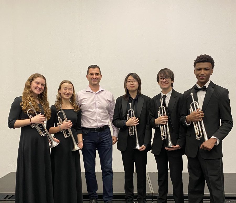 (Left to right) Band seniors Emma Ellis and Ella Martling, band sophomores Thu Dang and Michael Feuerborn, and band freshman Mathew Harper qualify for the National Trumpet Competition (NTC) with the help of artist-in-residence Veselin Bozhilov (third from the left). 