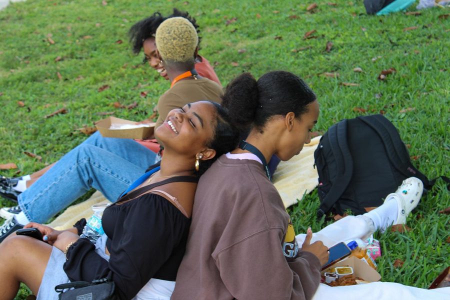 Theatre freshman Alina Wester and dance junior Trinity Smoot Ford sit back to back on Freshman Hill during Black Student Union’s (BSU) Unity Day picnic. Unity Day kicks off BSU’s Spirit Week for Black History Month, which consists of a new event for each day until Friday, Feb. 10.
