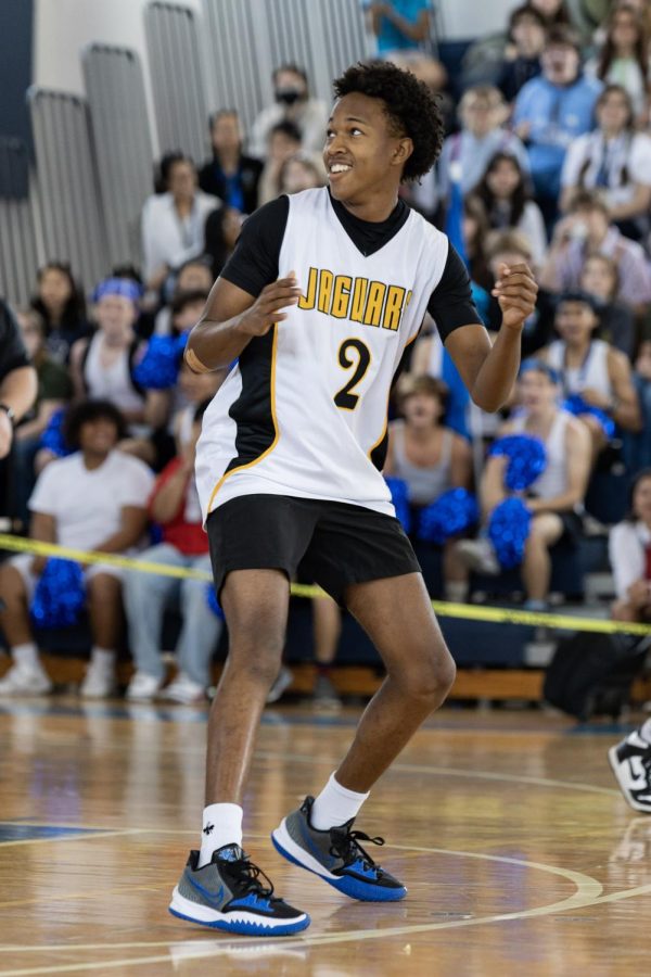 Watching the rebound, vocal junior Zidane Guerrier prepares to chase after the ball after the teachers were unsuccessful in their attempt to score a point. 