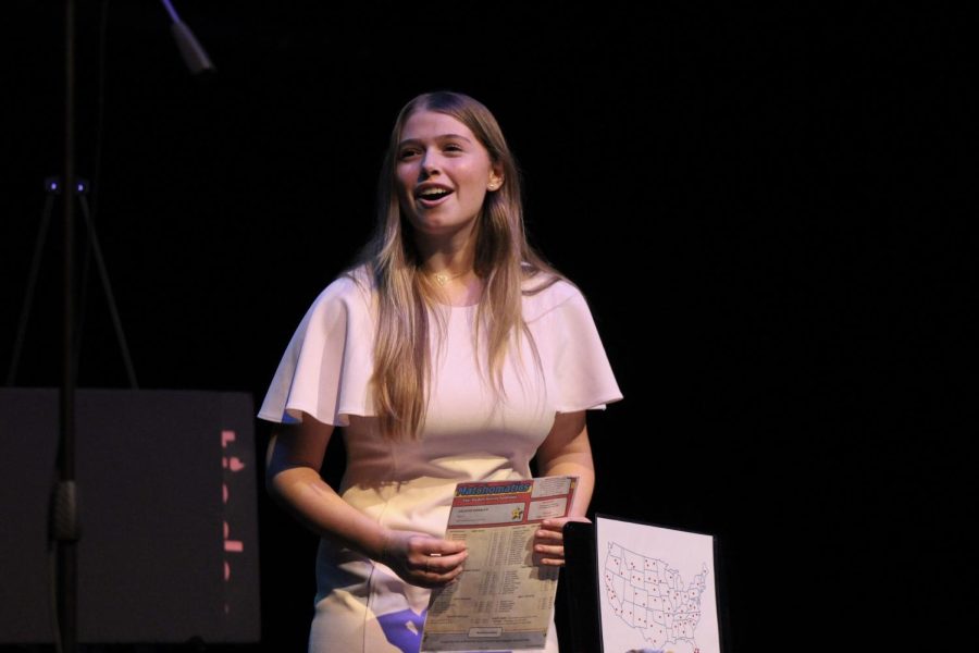 Holding a matchmaker handout, communications senior Kate Wagner explains in her informative speech, “Happily Ever After,” how she dreams to find her own “Prince Charming.” 
