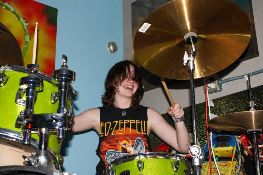 Digital media junior Coral Johnston plays the drums as her band rehearses “Can I Call You Tonight?” by Dayglow in preparation for the Battle of the Bands competition.
