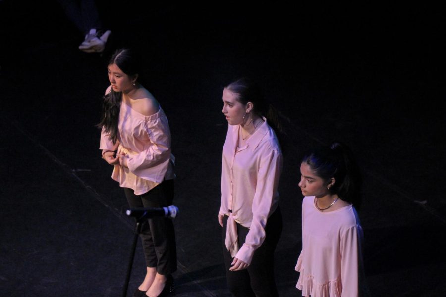 Dressed in pink, communications freshmen Vivian Jiang, Sienna Sossi, and Aiza Khan recite their poem, “How to Become the Ideal Girl,” a poem discussing feminism and beauty standards.
