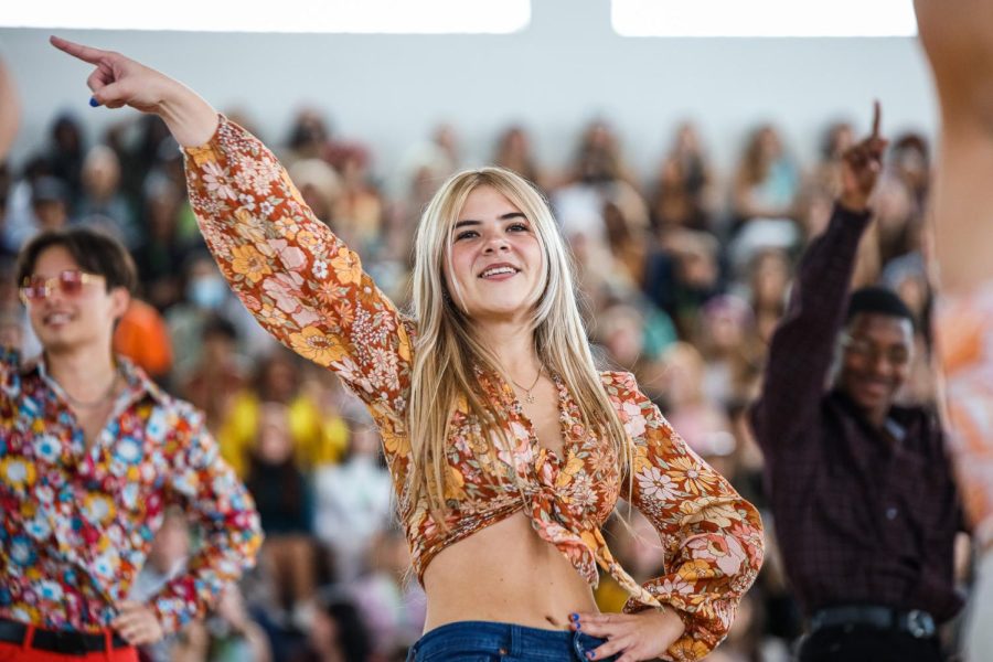 Digital media junior Ella Barlett points during the beginning of the juniors’ ‘70s generation dance.
