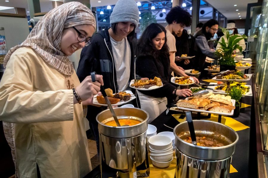 Scripps students Reema Iqbal, Hena Ahmed, a Harvey Mudd student Leila Bensaid, Fares Marzouk, a Pomona College student and other students, after breaking their Ramadan fast partake specially prepared halal meal for Muslims at Harvey Mudd College on Thursday, April 6, 2023, in Claremont, California.