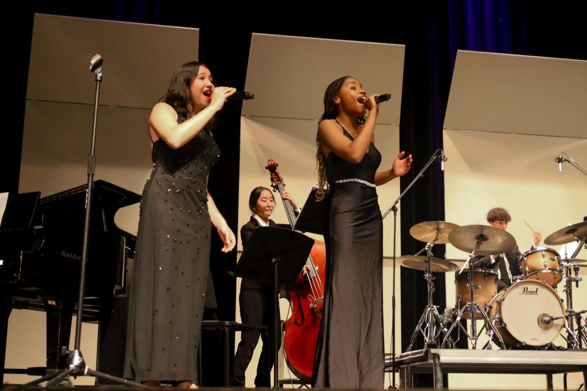 Vocal sophomore Sage Duke and vocal senior Christina Thompson perform a rendition of the song “Night and Day” at the jazz concert on Oct. 6. Ella Fitzgerald originally recorded the song, which was one of several jazz compositions performed.  