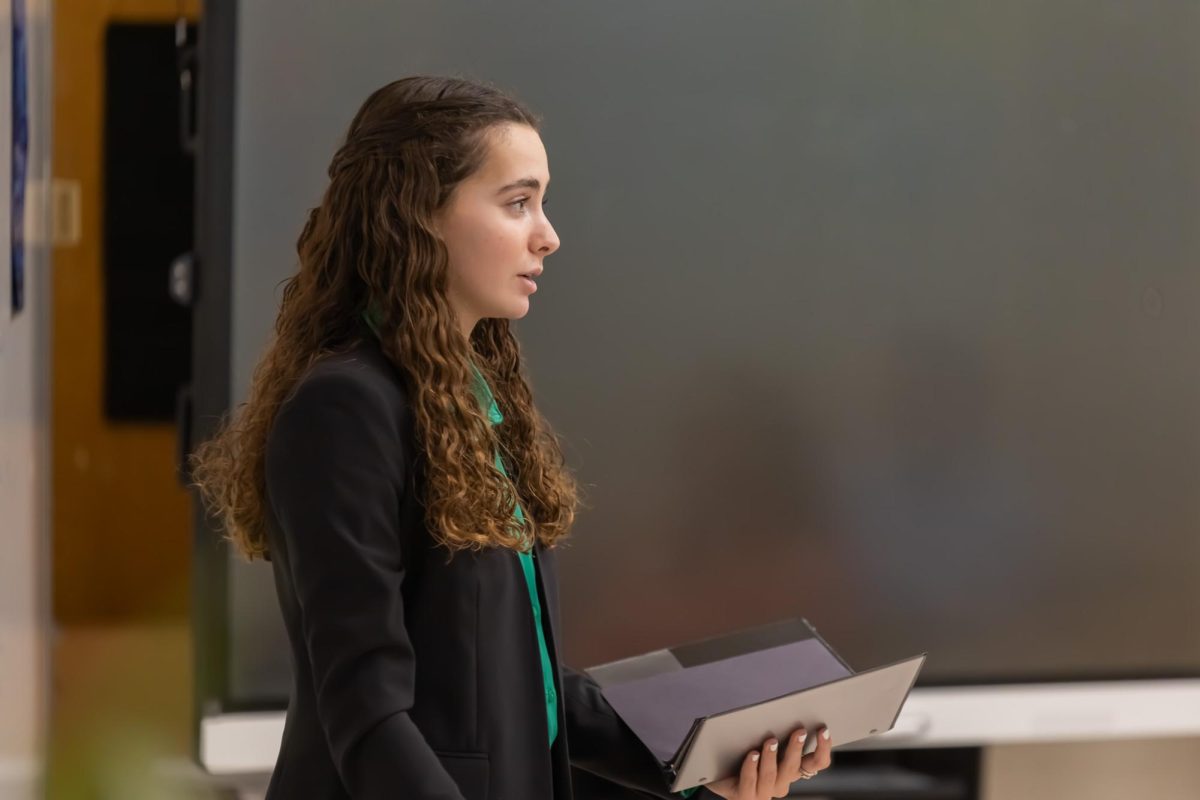 Performing her latest Oral Interpretation piece, “Tell-Tale Heart,” communications sophomore Olivia Kahn recites the introductory paragraph to her piece. Special rules allow Oral Interpretation performers to use a black binder during their performances, a feature special to this event.
