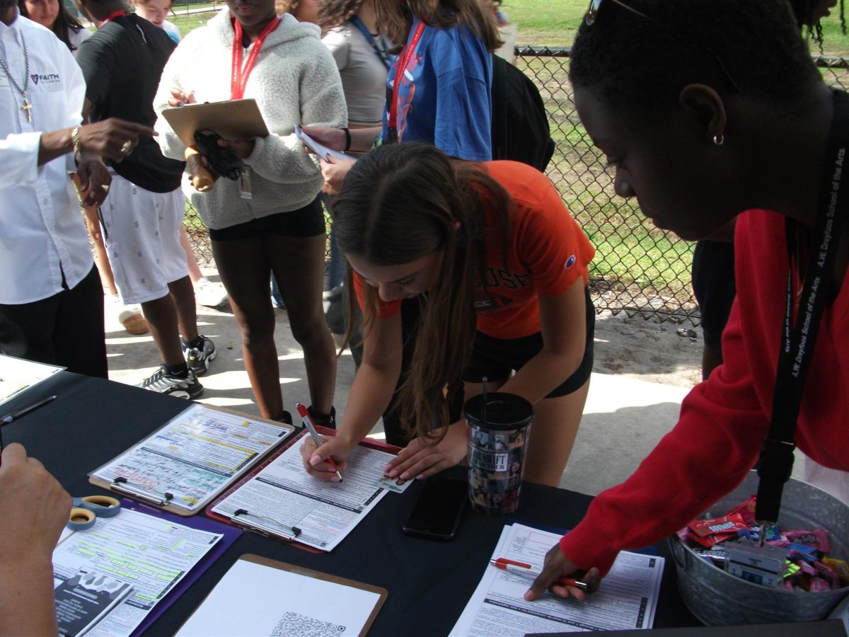 Using her ID, digital media senior Chloe Tovar fills out a voter registration form at BSU’s event. Photo courtesy of Tyson Jimerson