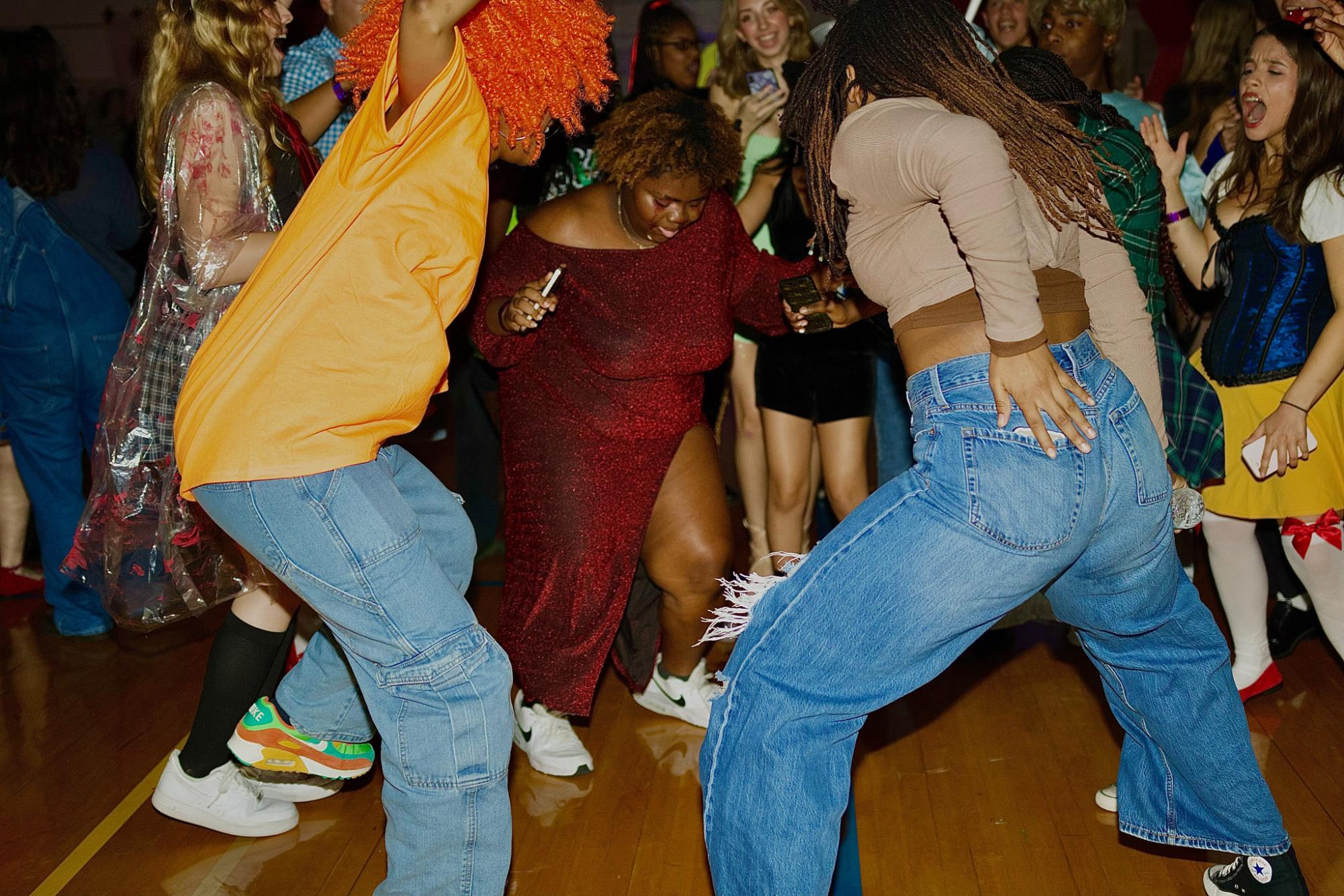 Dancing with friends, visual senior Cherise Hightower attends the Fall Dance. Students danced in the gym, walked through the haunted house in the media center, or attempted the escape room.