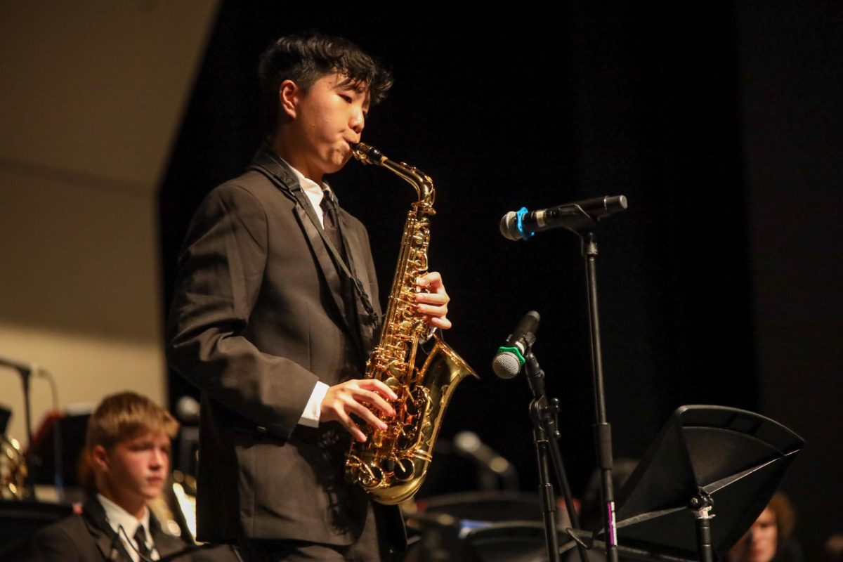 Improvising a jazz composition, band freshman Davis Yang performs at the first jazz concert of the year. Jazz includes breaks in the music where certain musicians can perform spontaneous unprepared solos. The concert, held on Oct. 6, split the jazz band into three different skill levels, each of which got a chance to perform. 
