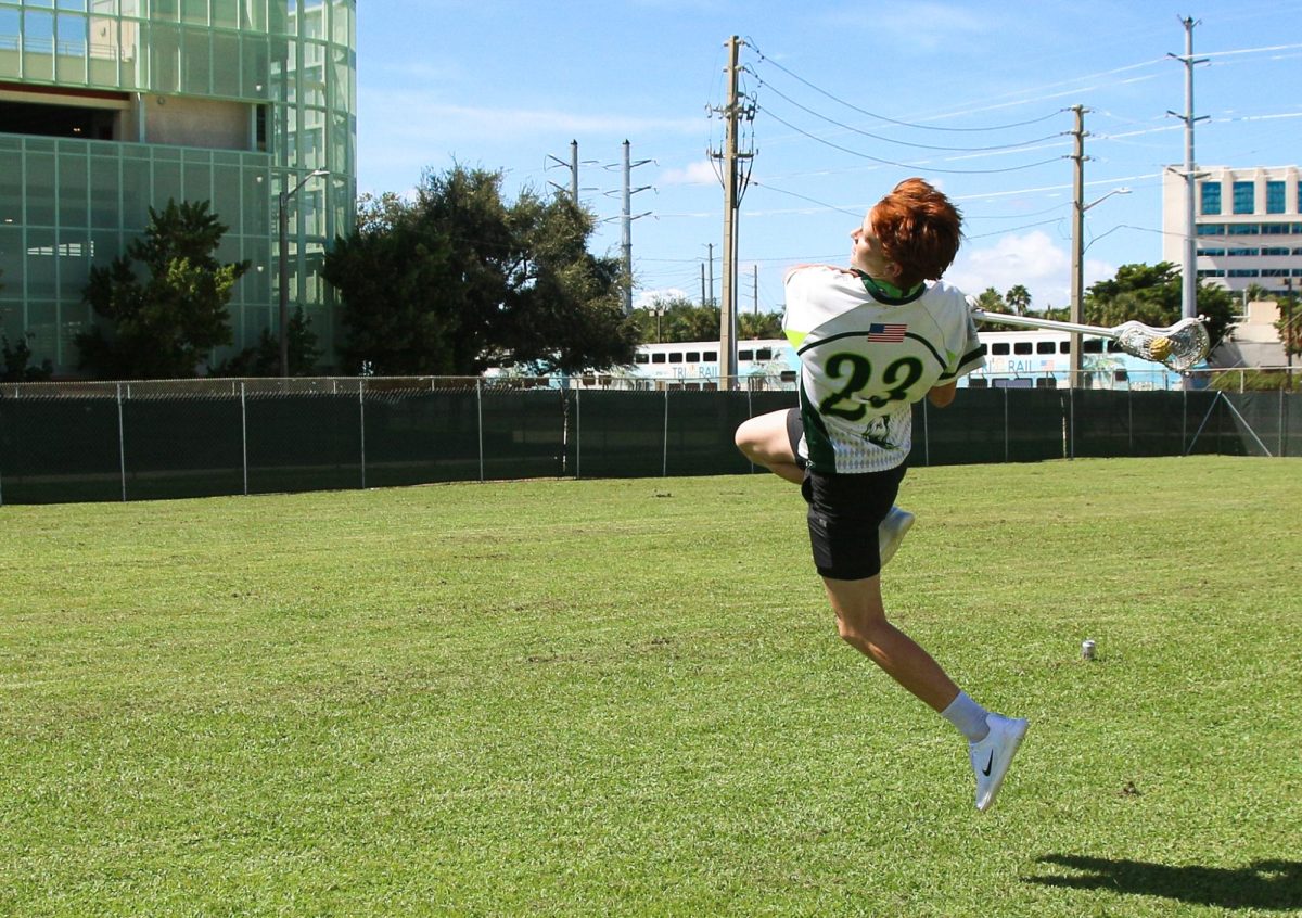 Strings sophomore Gavin Chandler leaps up in the air to pull off a jump shot, practicing for upcoming lacrosse tryouts at Palm Beach Atlantic High School.
