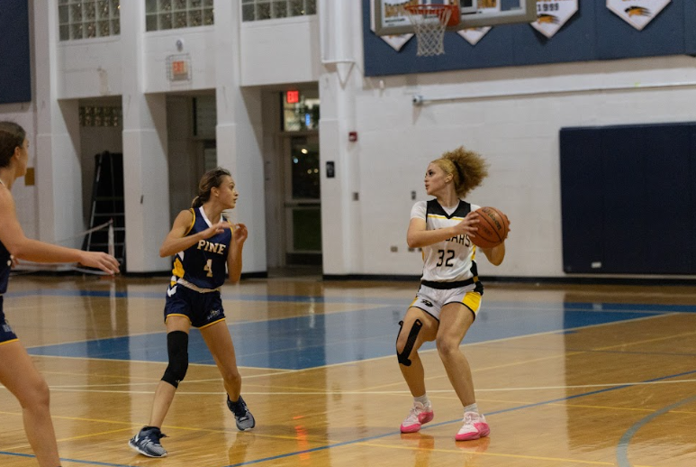 Digital media junior co-captain Briana Dean plays basketball with her team against The Pine School Dec. 7. The girls team lost the game 53 - 26.