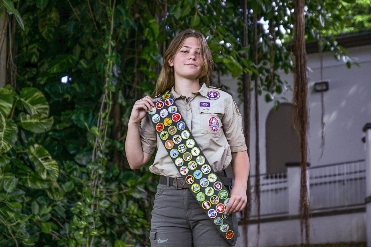 Communications junior Lily Kaminski poses in her uniform on Freshman Hill. Kaminski has earned 53 merit badges along with the rank of “Eagle Scout, the highest possible rank in Scouts BSA.   
