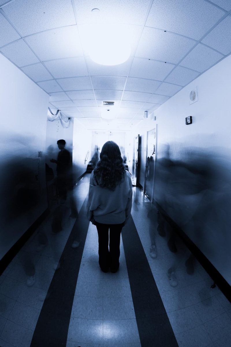 A posed long exposure photo of a subject inside a Building 1 hallway. According to a casual survey conducted by The Muse, 61.5% of students surveyed said they feel a little to very/fairly lonely.