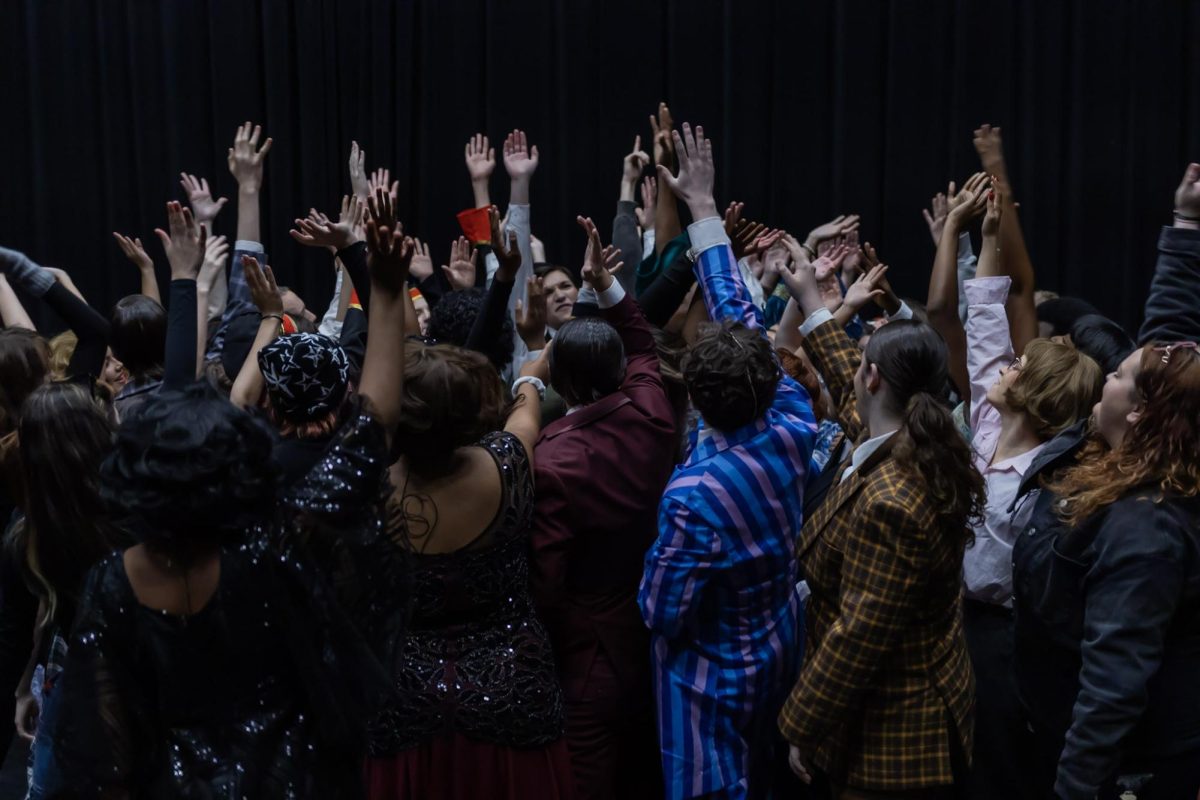 Chanting in unison, the cast of “Twelfth Night, or What You Will” bands together in the Brandt Black Box theater before the theatre preview. 