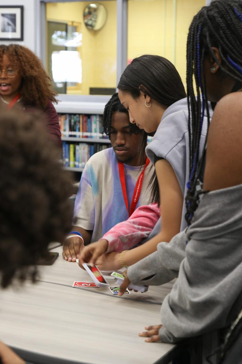 Shuffling cards together, theatre junior Adon Mckinnon and communications freshman Miya McKenzie prepare for a new game of Uno. 