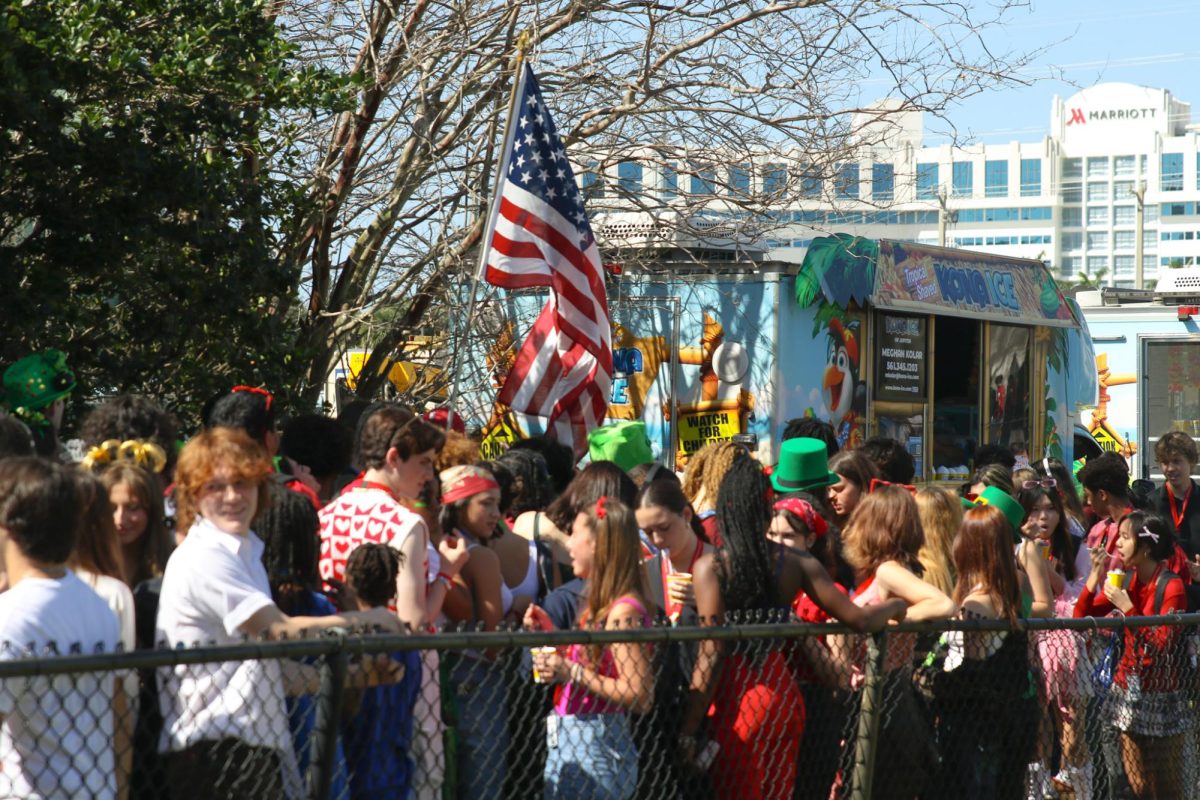 Waiting for a snow cone, students from all grades crowd around the Kona Ice trucks parked in front of the soccer field. This is the first time in two years that SGA has hosted a field day during Spirit Week.