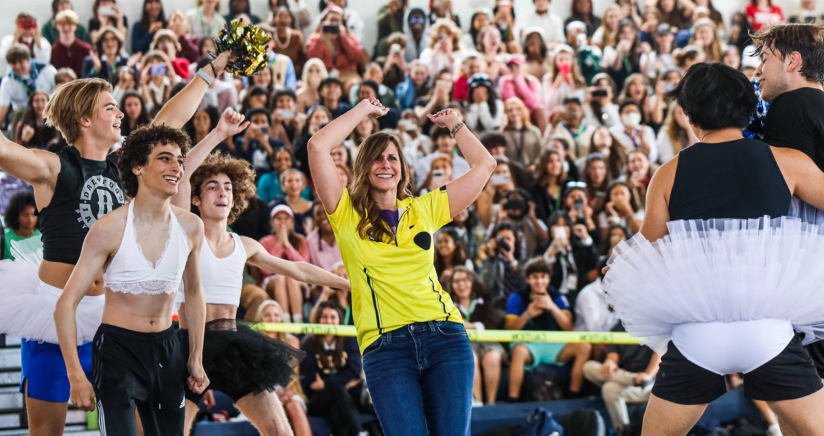 Principal Blake Bennett dances as she is circled by the senior Powderpuff boys in last year’s Spirit Week (Photo by Sofia Hennessey-Correa)