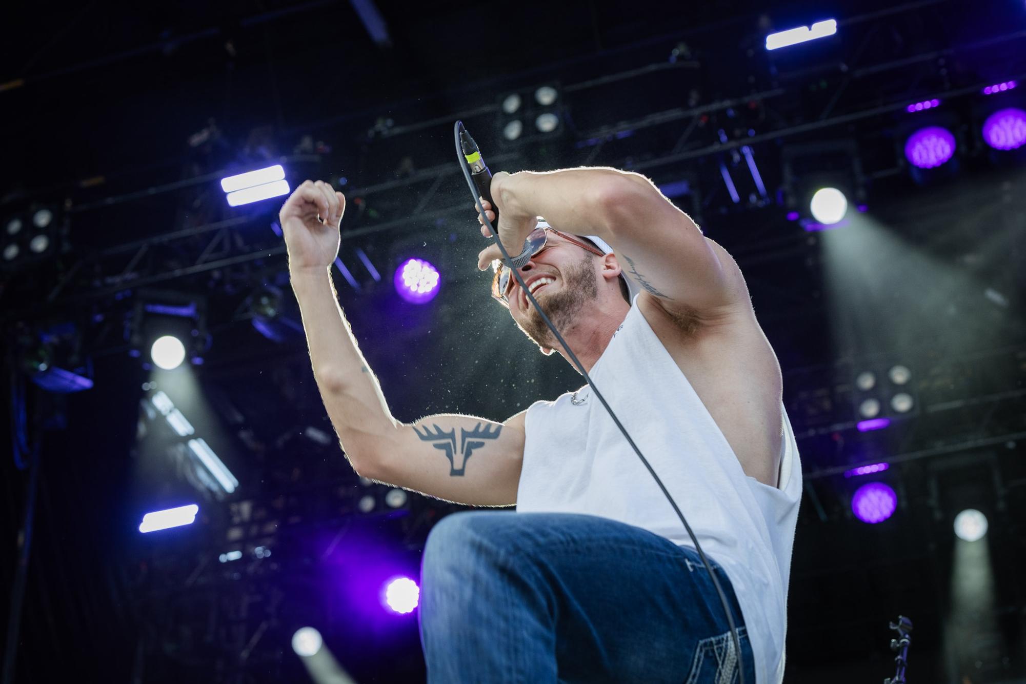 Yelling into his microphone, country musician Noah Hunton performs at SunFest as part of his mini south-Floridian tour, across venues from West Palm Beach to Key West.
