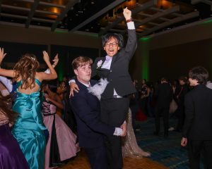 Clenching his hand into a fist at the beat drop of a song, piano junior Matthew Reyes gets lifted into the air by vocal junior Jason Robins.
