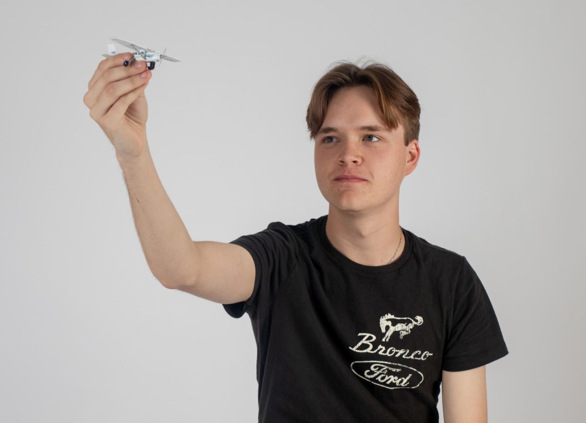  Vocal senior Sebastian Reynolds examines a model of an aircraft. Through his passion for flying planes, Reynolds hones his skills and utilizes his experience in the air to improve. “Looking back, being 18 years old and being a pilot is just so surreal because this has been a dream of mine for a decade now,” Reynolds said. “It's huge to have his accomplishment finally.” 