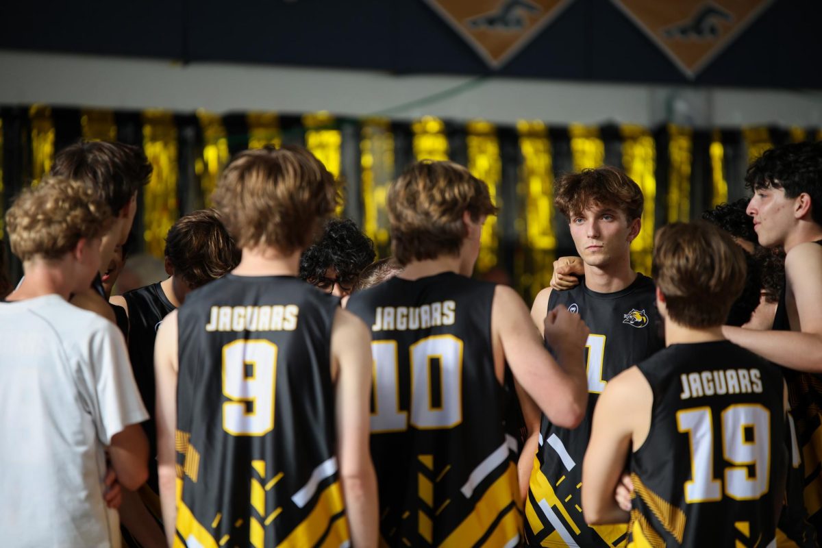Huddling up, digital media senior Joshua Molnar communicates game plans and strategies with the boys volleyball team. “The most challenging part this year was finding ways to stay connected and motivated when we hit a slow patch mid-season or end season," Molnar said. "We weren’t clicking as a team for a while…I tried to help by setting the tone in practices, bringing the energy even on the off days and making sure no one felt alone in the struggle.”