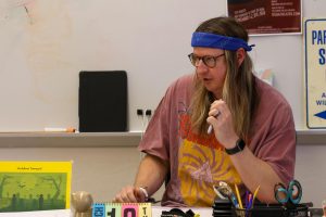 Hosting a lunch study session, math teacher Joshua Millstein explains how to calculate equations to his students. Outside of class time, Millstein hosts study sessions for students during lunch, in which he targets their shortcomings. 