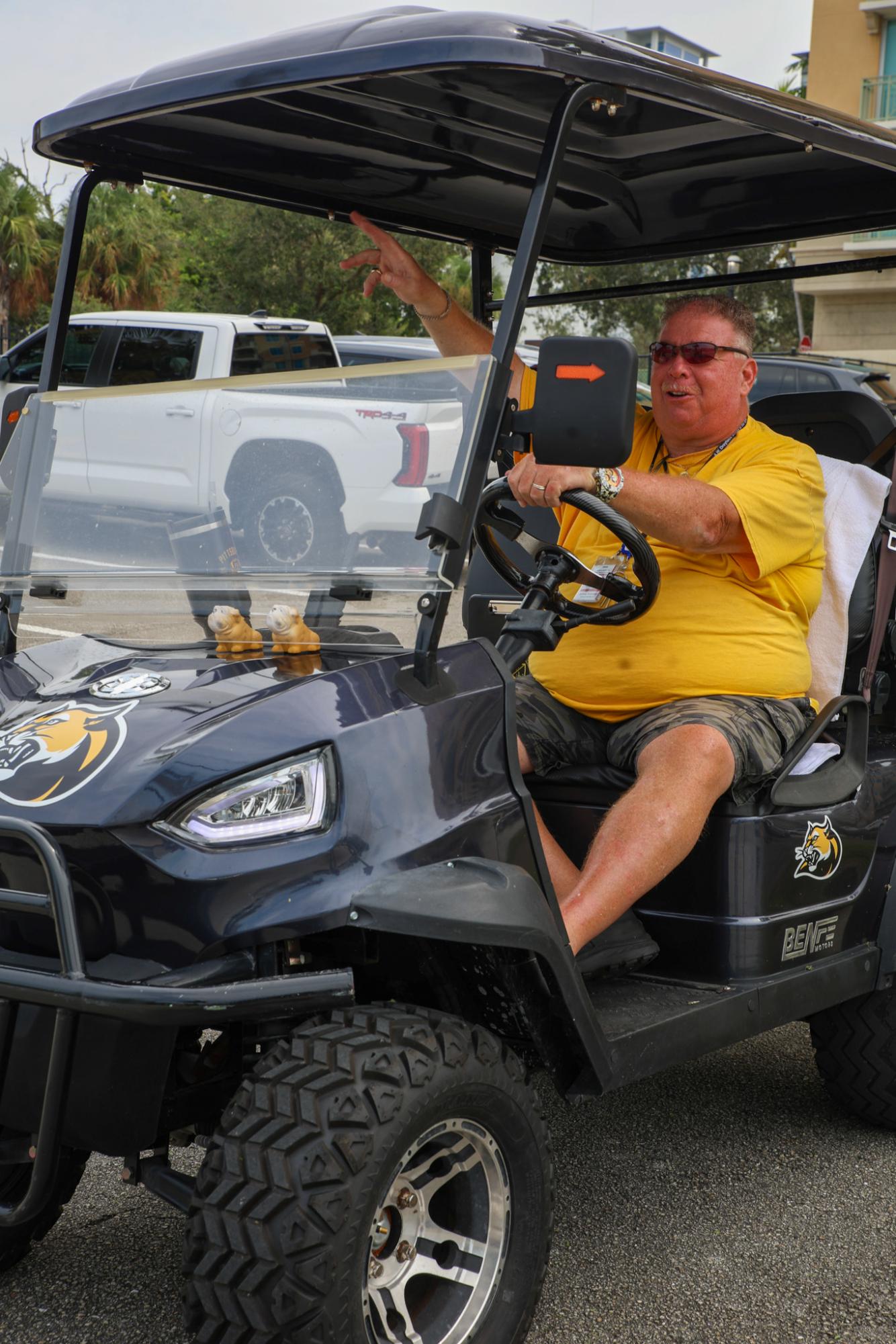 Giving directions to a driver exiting the campus, Mr. Koronec, the school monitor, surveys the parking lot during the students’ lunch hours. As part of keeping the campus safe, Mr. Koronec makes sure every driver is accounted for. “If I don't recognize you, you're supposed to stop,” Mr. Koronec said. “I ask you who you are, they tell me who they are, then I proceed.”
