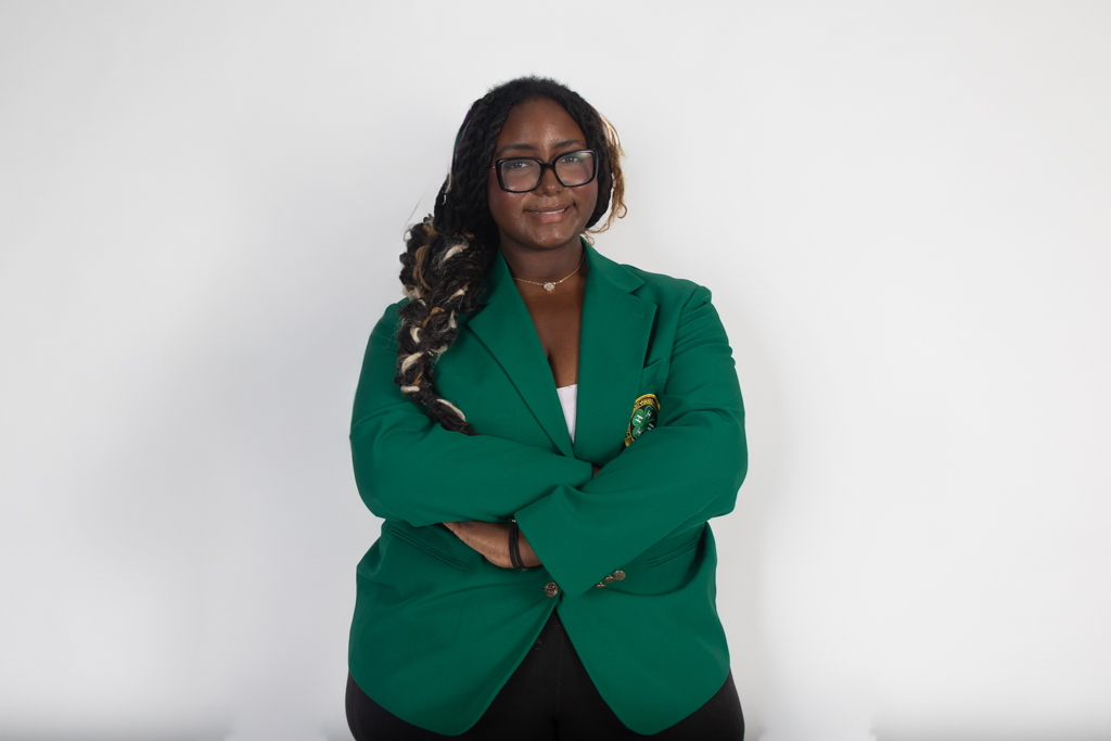 Smiling with her arms crossed, 4-H reporter and strings senior Musiq Williams poses for a photo. Williams was elected as the Florida 4-H State Council reporter for the Palm Beach chapter. 4-H is a national organization focused on educating students about various environmental and agricultural sectors.