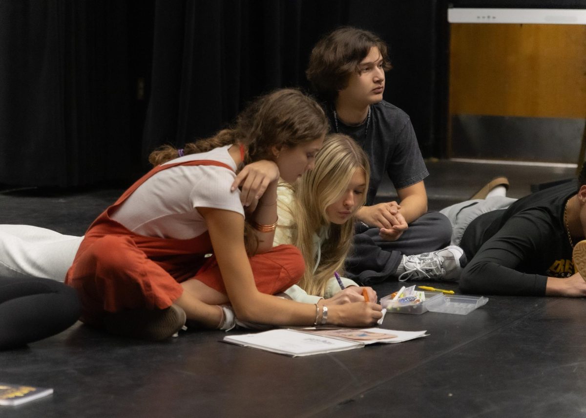 Listening in, theatre junior Malaika Bourgi-Gordon, who is movement captain as well as an understudy for Moaning Myrtle, works with the cast during a vocal exercise.
“This vocal work really helped me think about how I say each syllable…it really does affect how you see words because it’s like, you think of the alphabet in a whole new phonetic way,” Bourgi-Gordon said.
For the production of Harry Potter and the Cursed Child, the cast has to learn how to speak with a vocal dialect.
“The whole show is completely British,” Bourgi-Gordon said. “So for the people who do not know the rules (of British dialect), this definitely helps us sound a little more competent and makes it sound better for the whole show.”