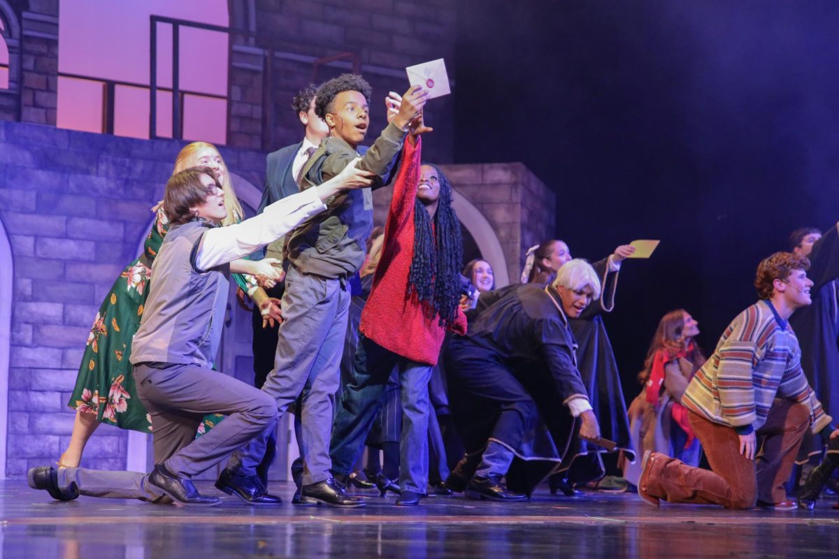 Reaching out for his Hogwarts acceptance letter, theatre senior Kevontay Oliver performs as the lead role of Albus Potter, Harry Potter’s son, in the theatre preview night of “Harry Potter and the Cursed Child.” The play focuses on how Albus struggles with being in his father’s shadow and having to fulfill his legacy.